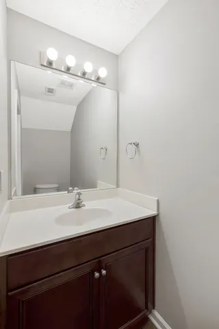 a bathroom with a sink vanity and a mirror