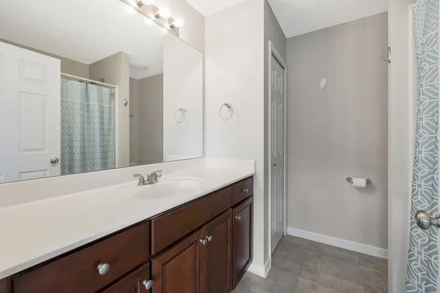 a bathroom with a double vanity sink and mirror