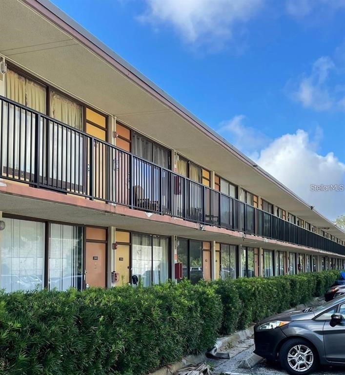 7900 South Orange Blossom Trail, Unit 2084 Orlando, FL 32809 - Photo 1 of 16 a front view of a building with parking