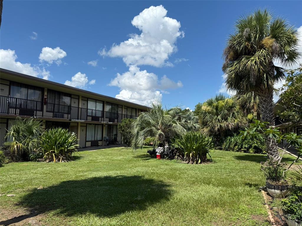 7900 South Orange Blossom Trail, Unit 2084 Orlando, FL 32809 - Photo 16 of 16 a view of a backyard with plants and a patio