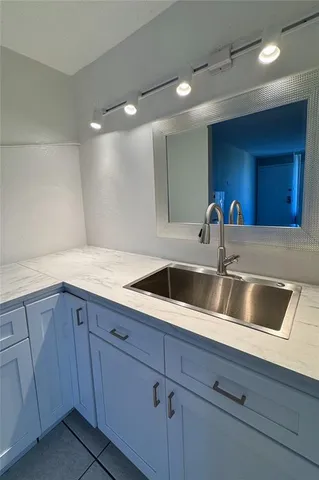 a kitchen with a sink and cabinets