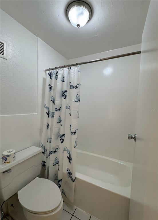 7900 South Orange Blossom Trail, Unit 2084 Orlando, FL 32809 - Photo 7 of 16 a white toilet and shower in a bathroom