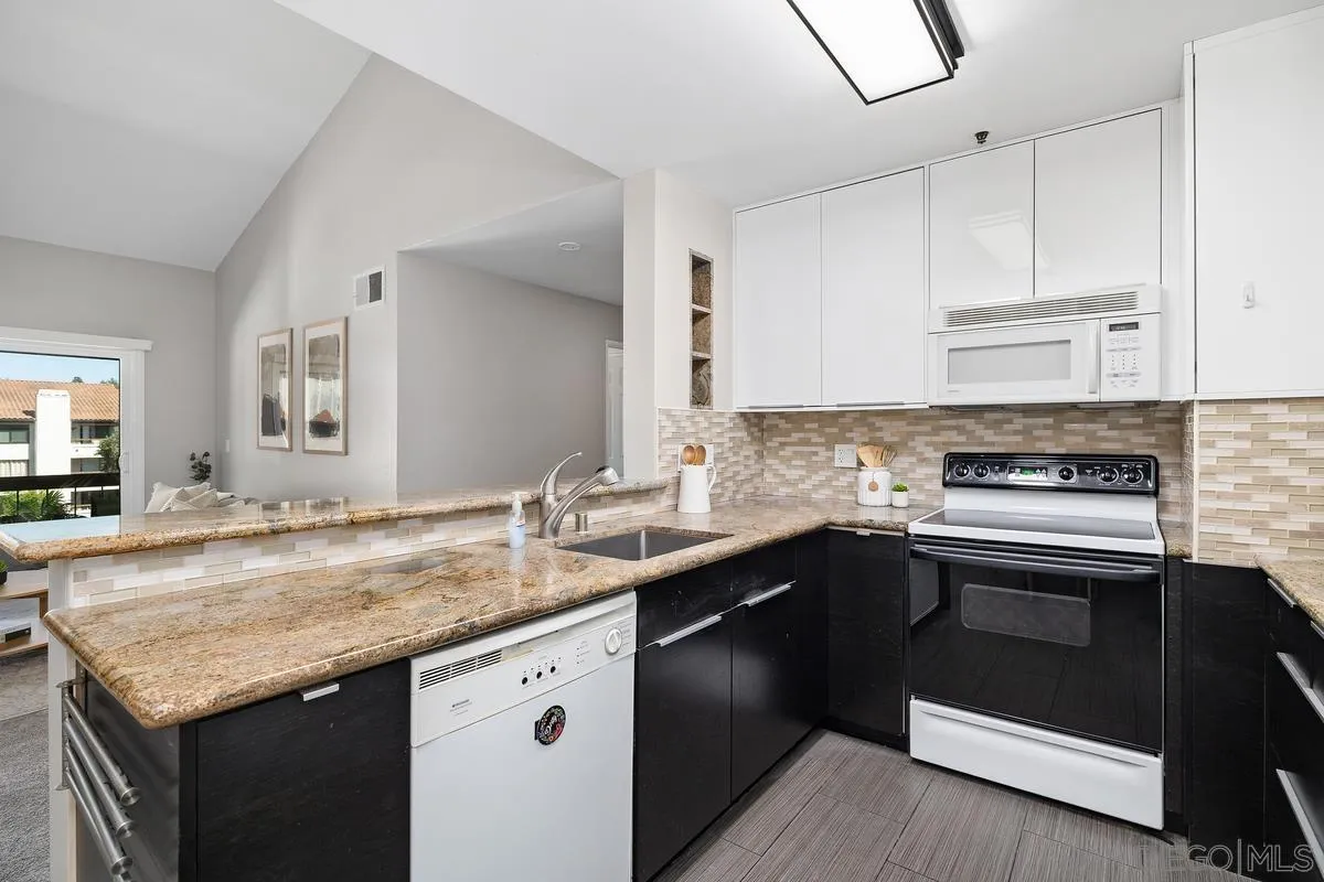 5705 Friars Road, Unit 60 San Diego, CA 92110 - Photo 11 of 49 a kitchen with stainless steel appliances granite countertop a sink stove and cabinets