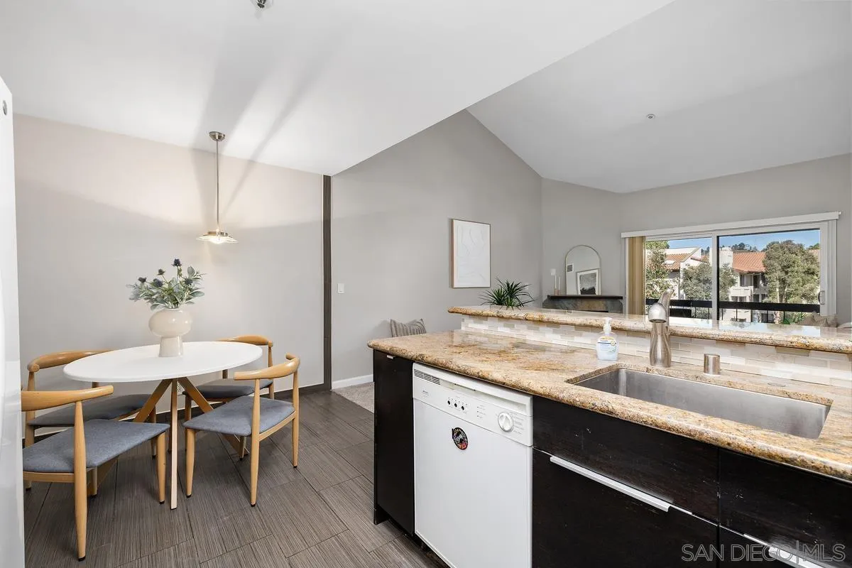 5705 Friars Road, Unit 60 San Diego, CA 92110 - Photo 12 of 49 a kitchen with a table and chairs in it
