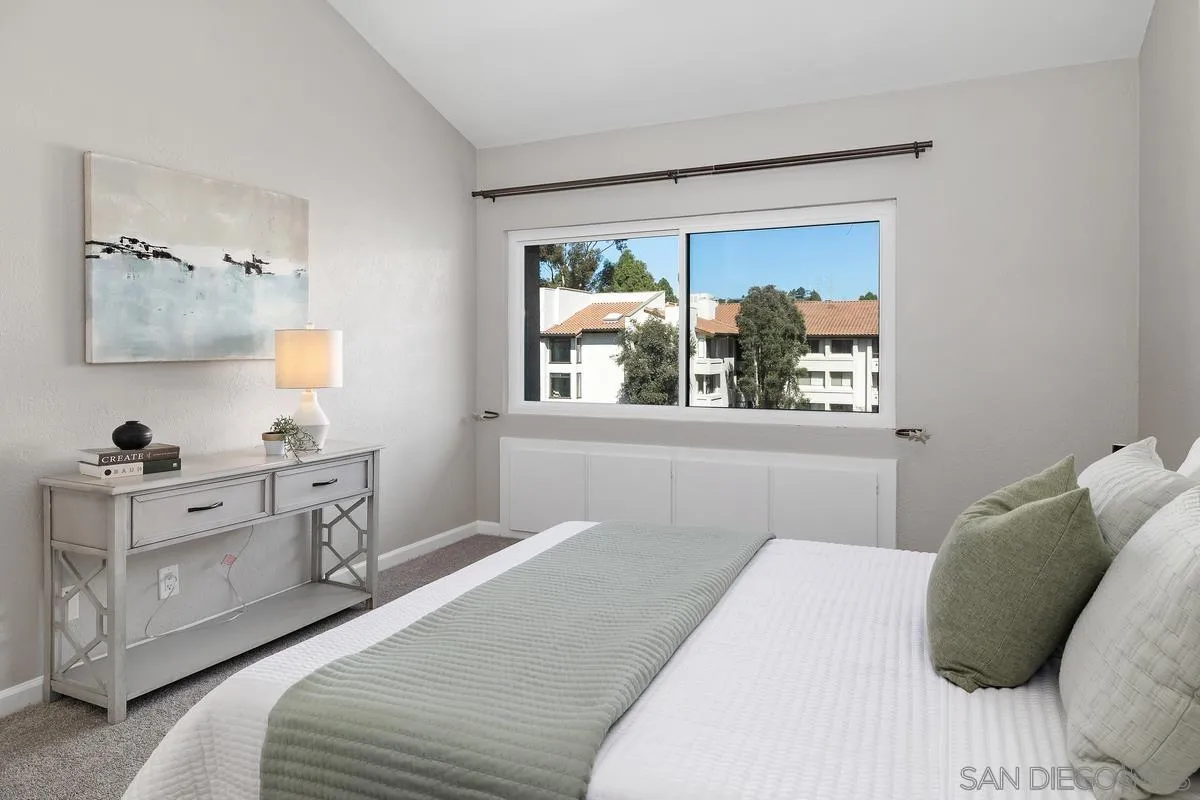 5705 Friars Road, Unit 60 San Diego, CA 92110 - Photo 14 of 49 a bedroom with a large bed and a window