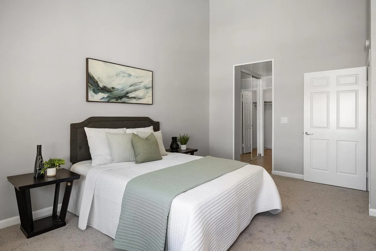 5705 Friars Road, Unit 60 San Diego, CA 92110 - Photo 15 of 49 a bedroom with bed and painting on the wall