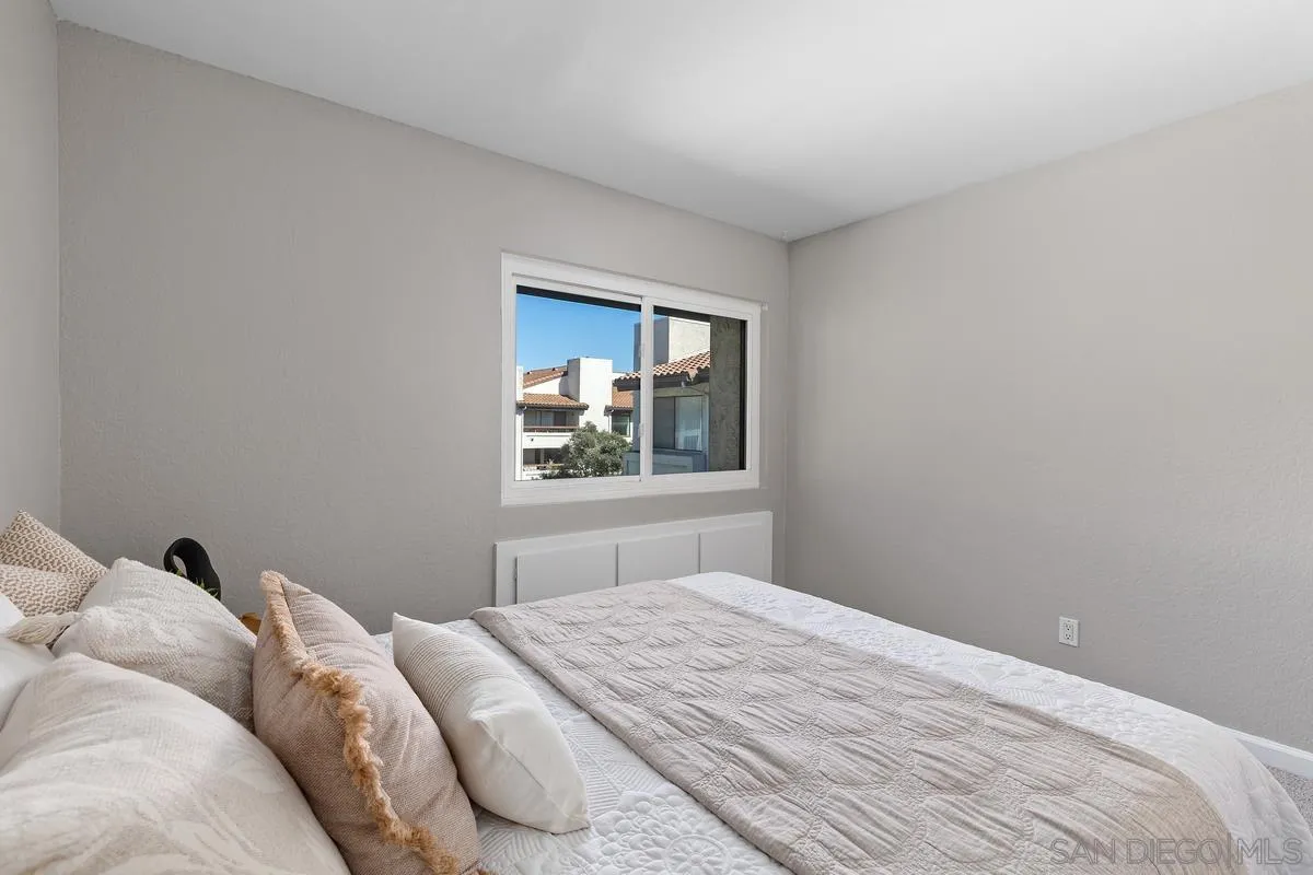 5705 Friars Road, Unit 60 San Diego, CA 92110 - Photo 21 of 49 a bedroom with a bed and window