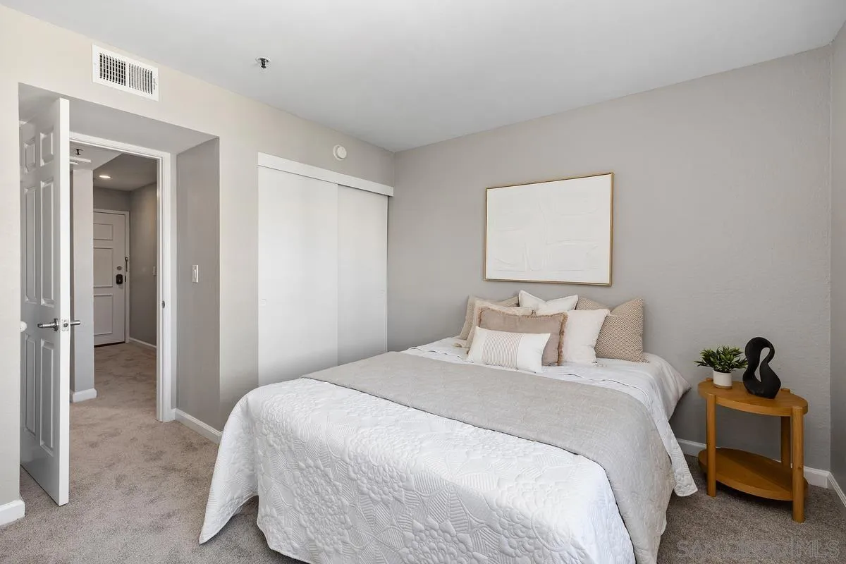 5705 Friars Road, Unit 60 San Diego, CA 92110 - Photo 22 of 49 a bedroom with a bed and a painting