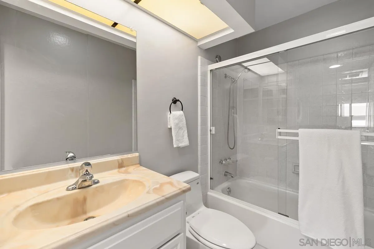 5705 Friars Road, Unit 60 San Diego, CA 92110 - Photo 24 of 49 a bathroom with a bathtub shower sink vanity and toilet