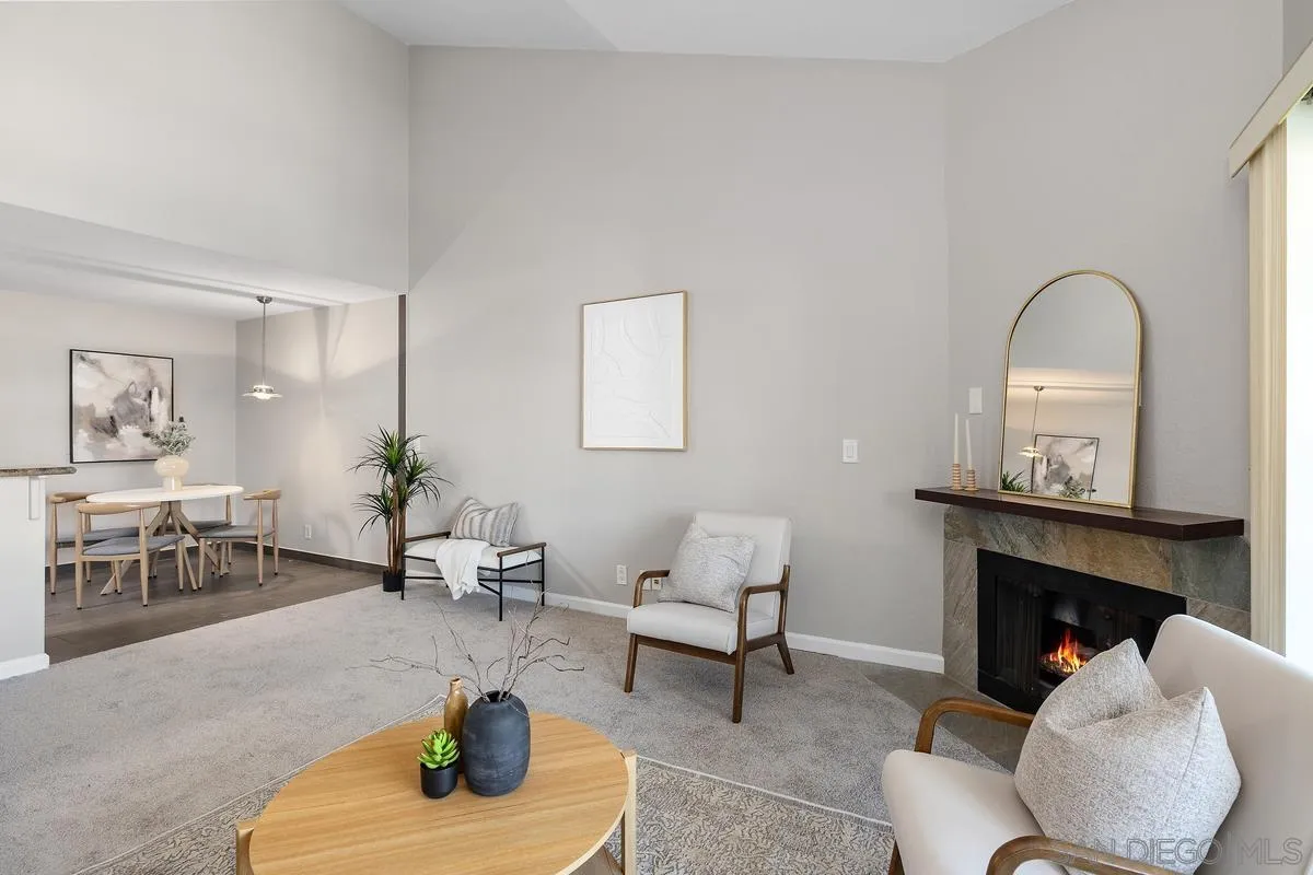 5705 Friars Road, Unit 60 San Diego, CA 92110 - Photo 5 of 49 a living room with furniture a fireplace and a table