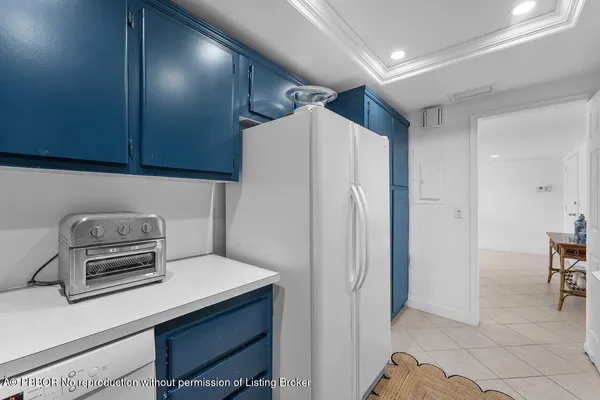 a kitchen with a refrigerator and a stove top oven