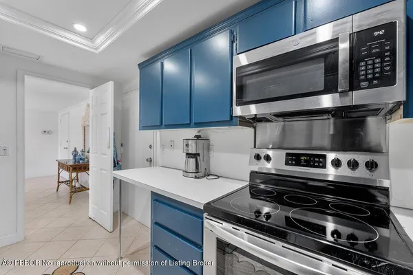 a kitchen with a stove a microwave and wooden cabinets
