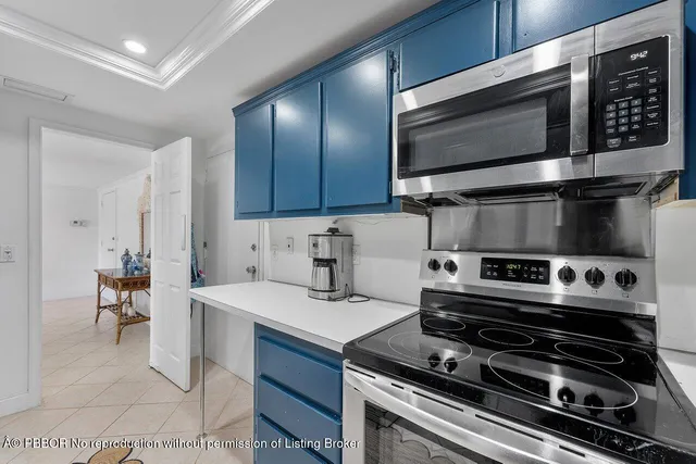 a kitchen with a stove a microwave and wooden cabinets