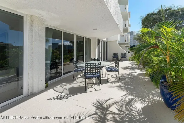 a chair and table in front of a house