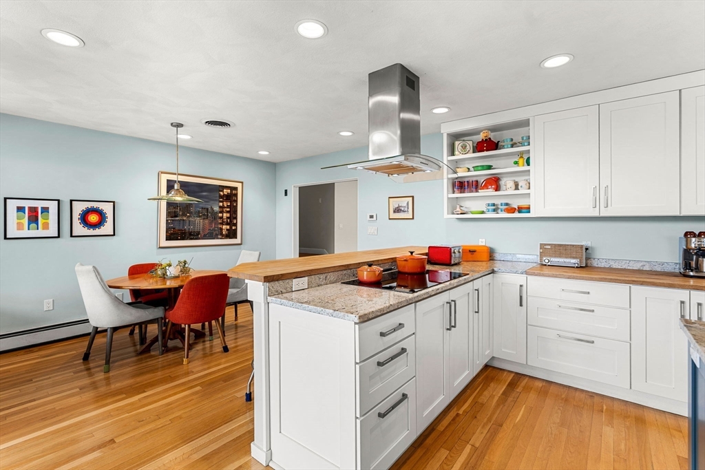 58 Leicester Road Marblehead, MA 01945 - Photo 9 of 42 a kitchen that has a lot of cabinets in it and wooden floors
