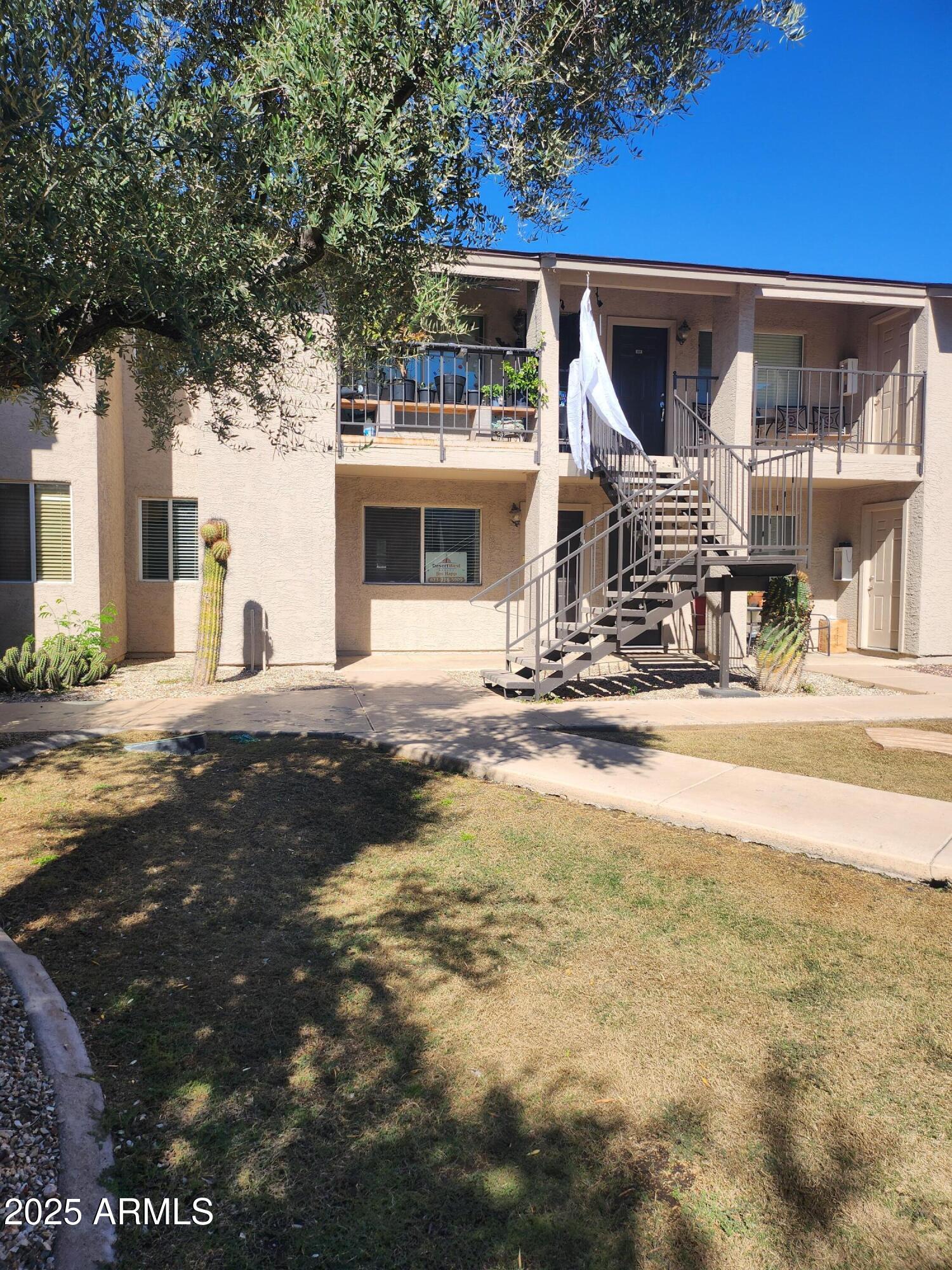 12440 North 20th Street, Unit 102 Phoenix, AZ 85022 - Photo 13 of 13 a front view of a house with a yard