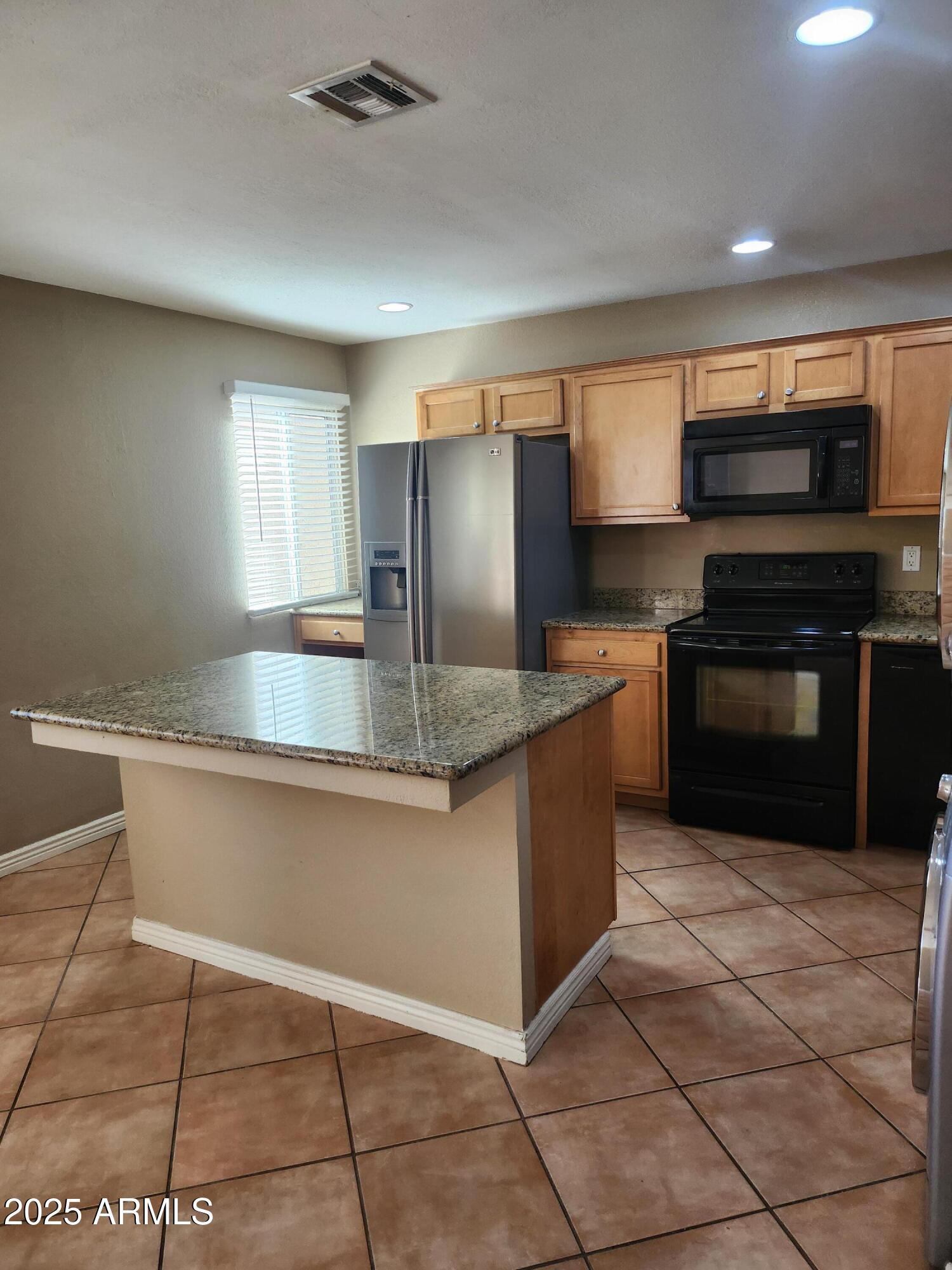 12440 North 20th Street, Unit 102 Phoenix, AZ 85022 - Photo 3 of 13 a kitchen with stainless steel appliances granite countertop a sink and a microwave