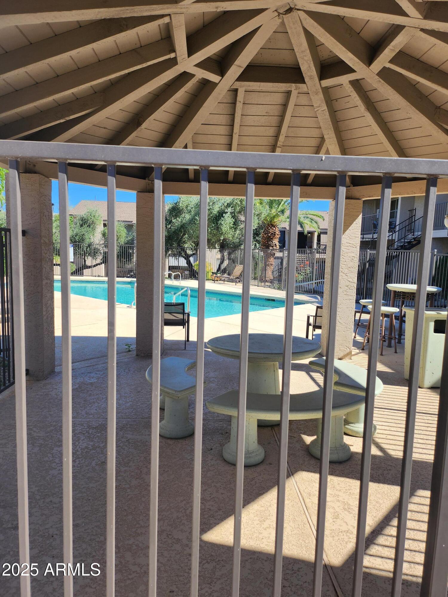 12440 North 20th Street, Unit 102 Phoenix, AZ 85022 - Photo 5 of 13 a porch area with table and chairs