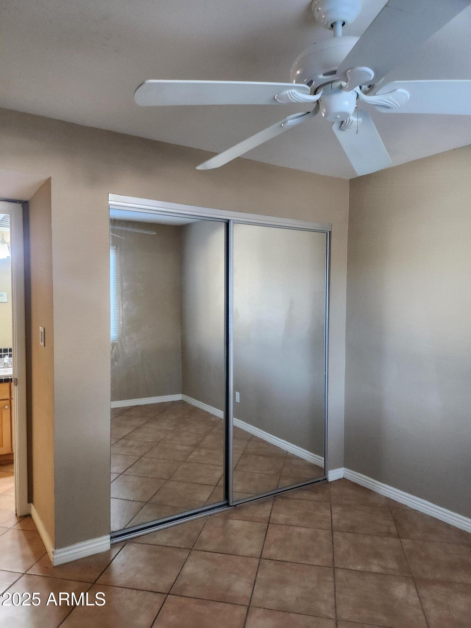 12440 North 20th Street, Unit 102 Phoenix, AZ 85022 - Photo 7 of 13 an empty room with fan and entryway