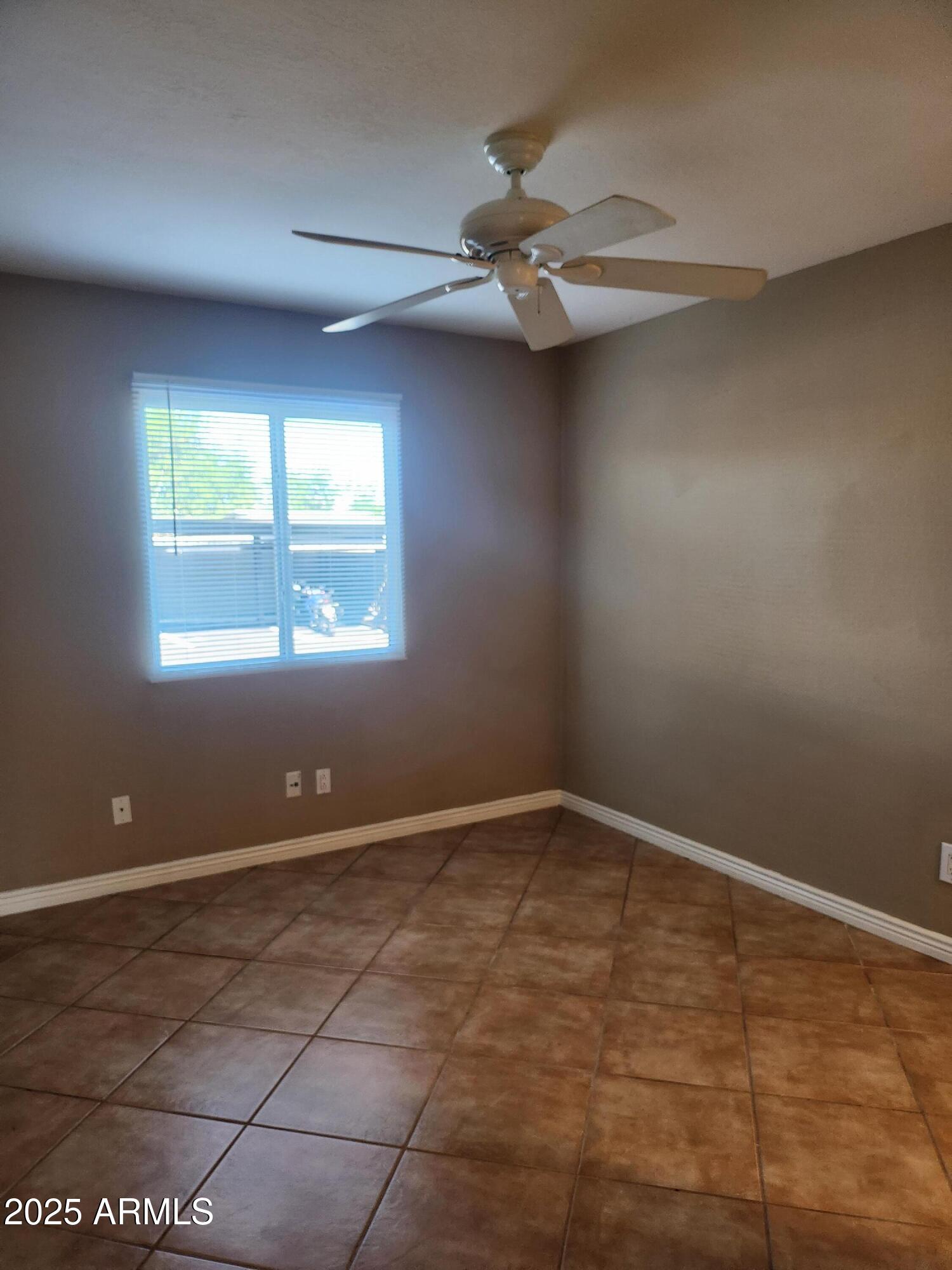 12440 North 20th Street, Unit 102 Phoenix, AZ 85022 - Photo 8 of 13 an empty room with windows and fan