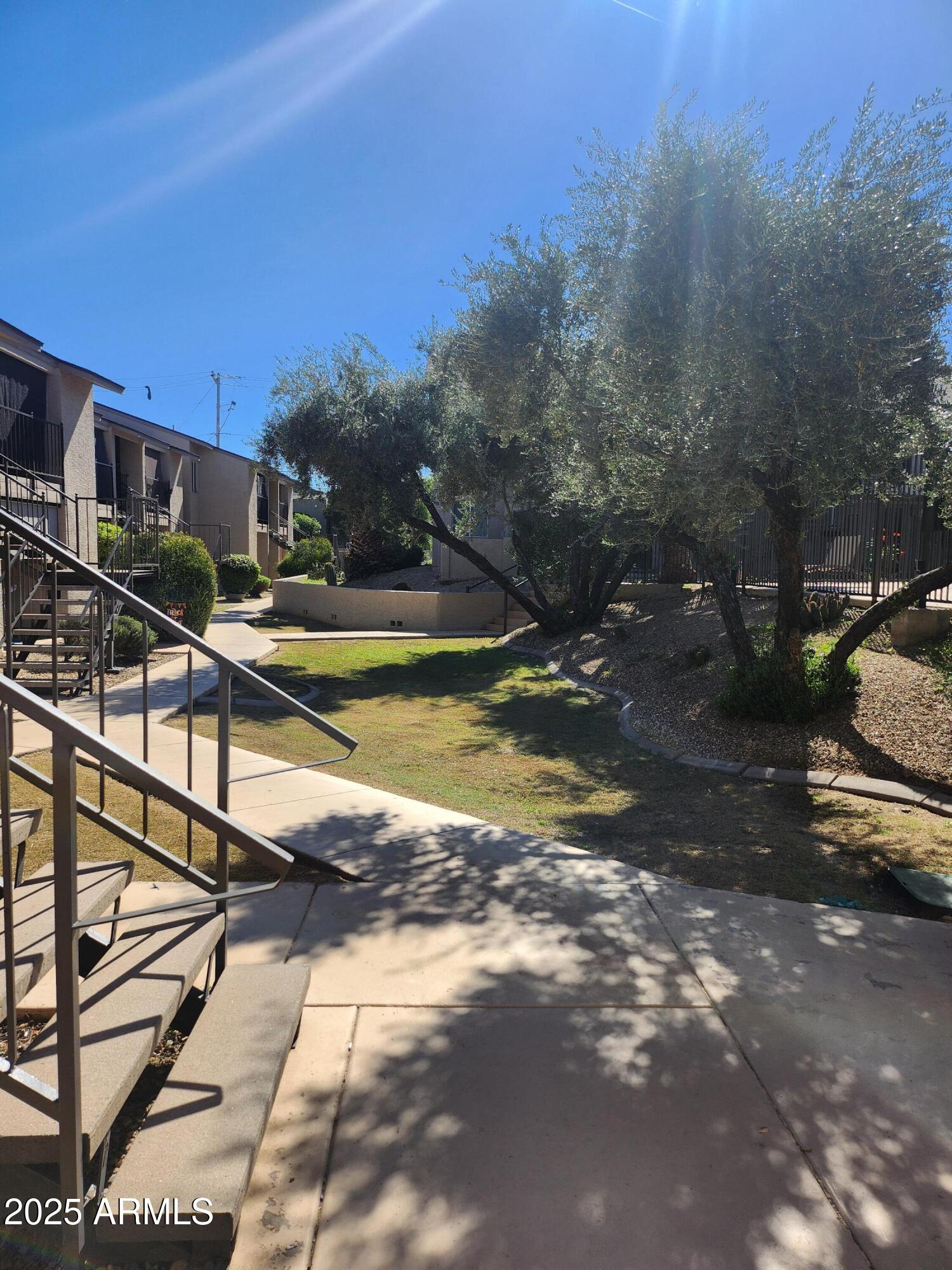 12440 North 20th Street, Unit 102 Phoenix, AZ 85022 - Photo 10 of 13 a view of a swimming pool with a yard