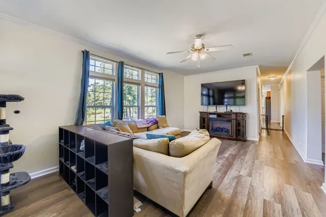 a living room with furniture and a wooden floor