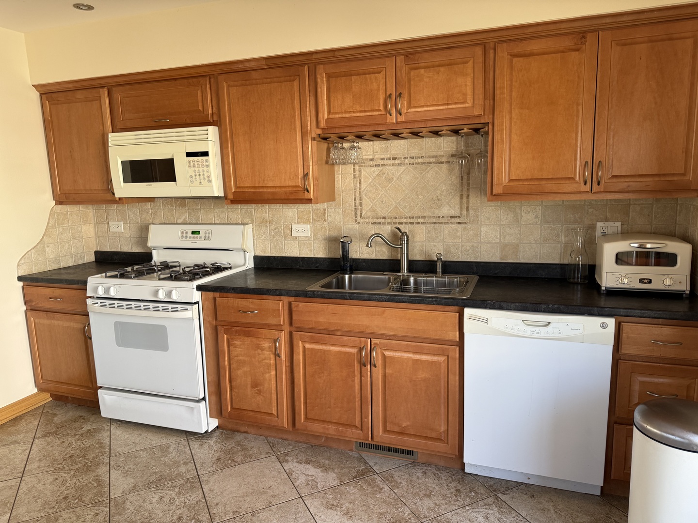 414 Audubon Road Streamwood, IL 60107 - Photo 3 of 6 a kitchen with stainless steel appliances granite countertop a sink stove and cabinets