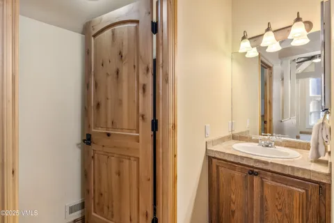 a bathroom with a granite countertop sink and a mirror