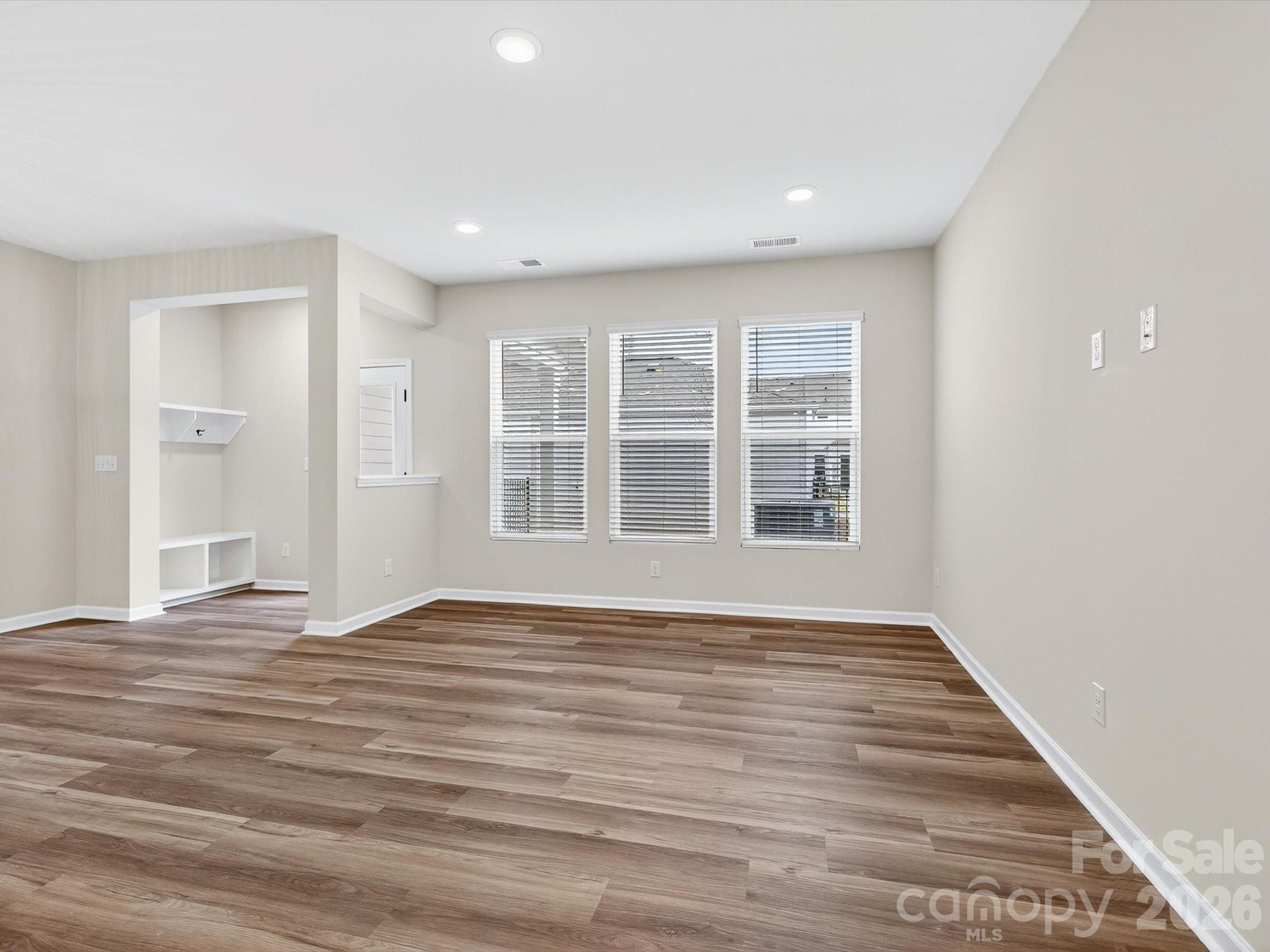 11441 Prosperity Church Road Huntersville, NC 28078 - Photo 14 of 32 a view of an empty room with wooden floor and windows
