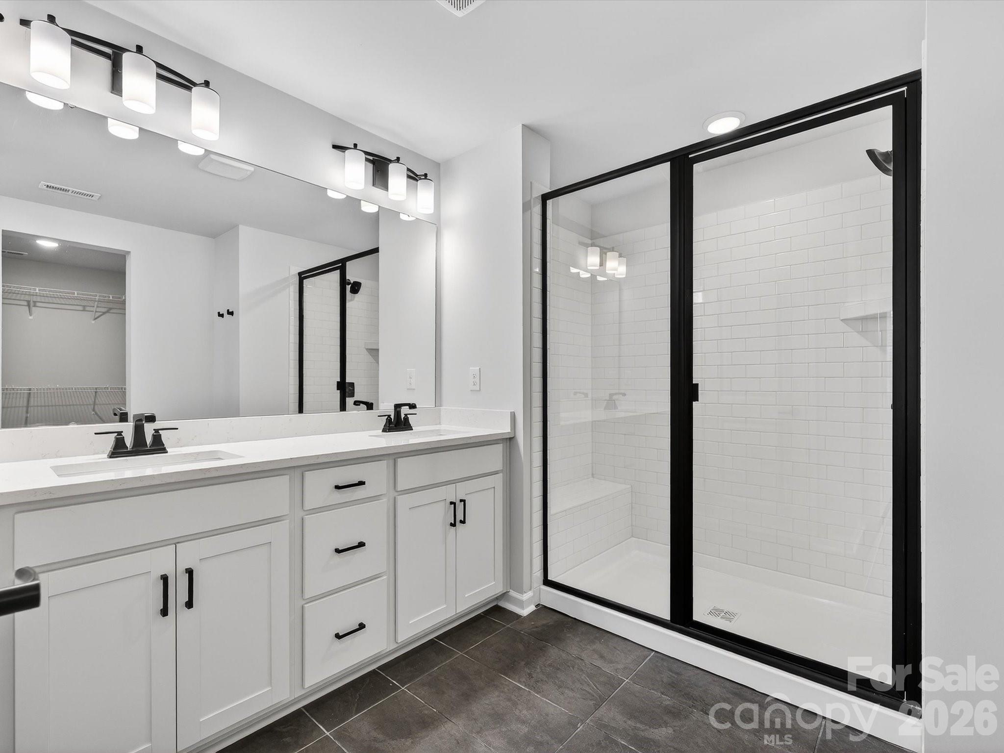 11441 Prosperity Church Road Huntersville, NC 28078 - Photo 20 of 32 a bathroom with a double vanity sink and mirror