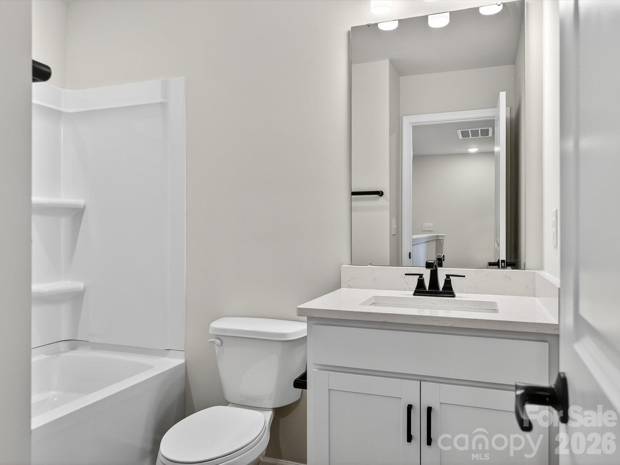 11441 Prosperity Church Road Huntersville, NC 28078 - Photo 24 of 32 a bathroom with a sink toilet vanity and tub