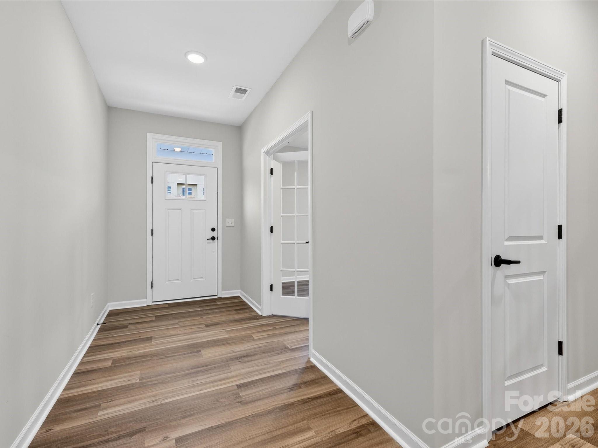 11441 Prosperity Church Road Huntersville, NC 28078 - Photo 3 of 32 a view of a hallway with wooden floor and closet