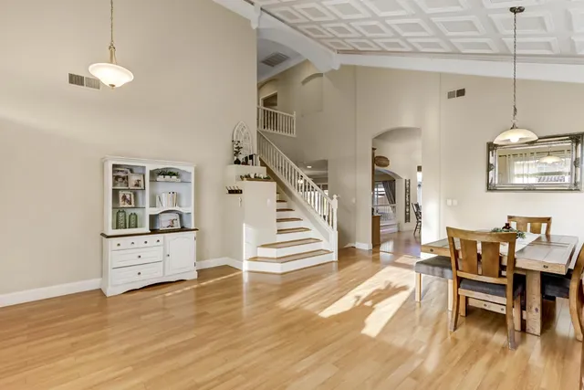 a view of a dining room with furniture wooden floor and chandelier