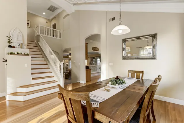a kitchen that has a kitchen island wooden cabinets and stainless steel appliances