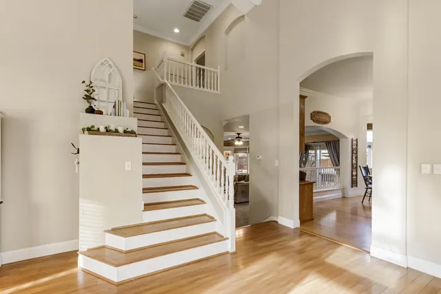 a kitchen with stainless steel appliances granite countertop a refrigerator and a stove top oven