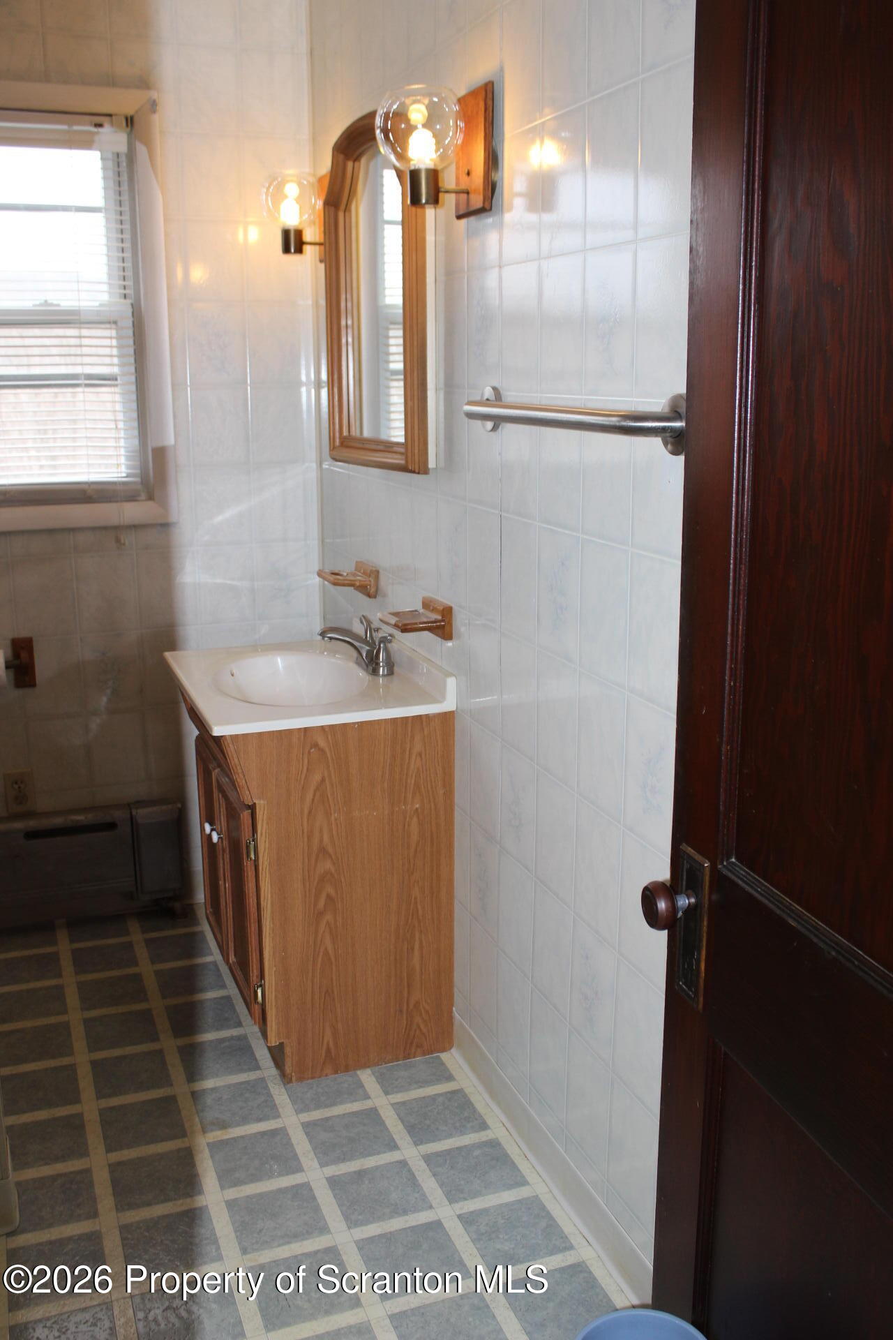 900 Wheeler Avenue Scranton, PA 18510 - Photo 17 of 25 a bathroom with a sink and a mirror