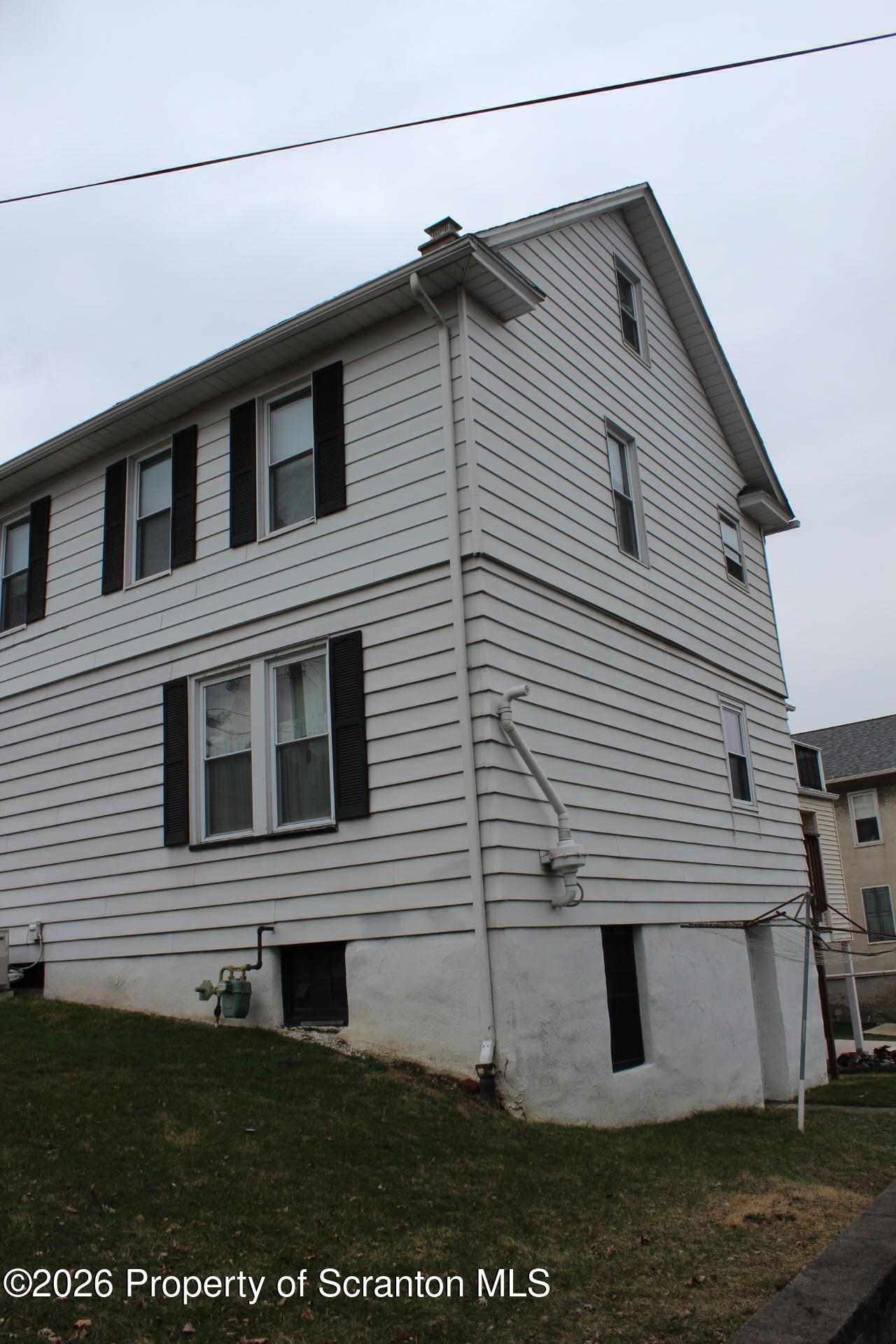 900 Wheeler Avenue Scranton, PA 18510 - Photo 3 of 25 a view of a house with a yard