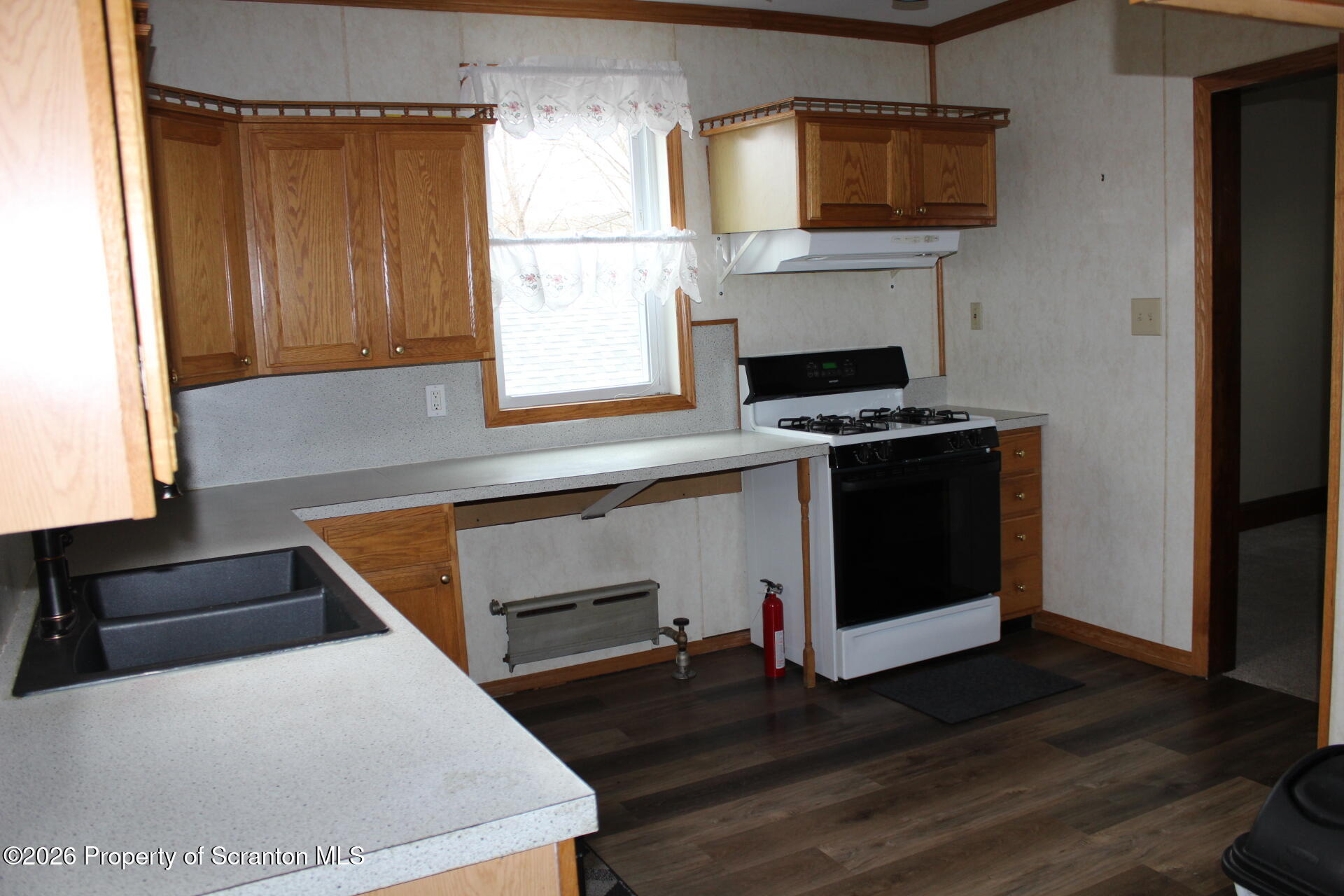 900 Wheeler Avenue Scranton, PA 18510 - Photo 10 of 25 a kitchen with wooden cabinets and a stove top oven