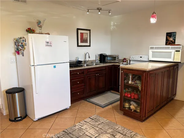 a kitchen with a stove a refrigerator and a sink