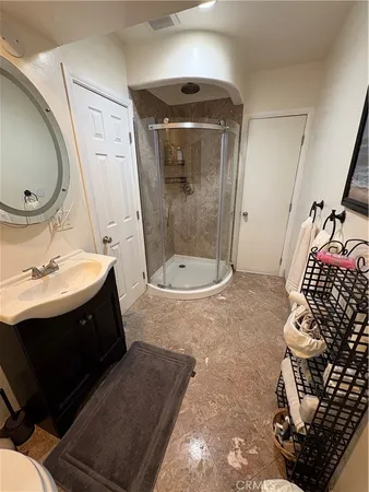 a bathroom with a sink toilet and shower