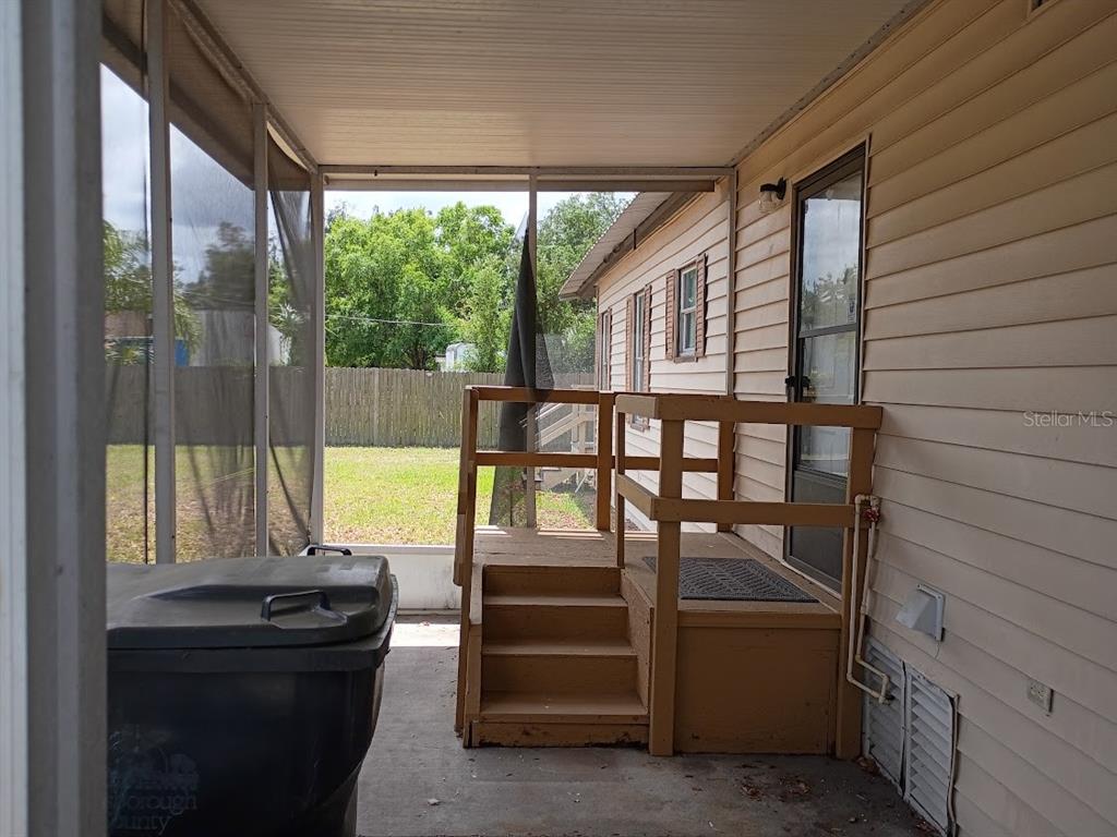 10411 Ratell Avenue Gibsonton, FL 33534 - Photo 7 of 15 a bedroom with a bed and large windows