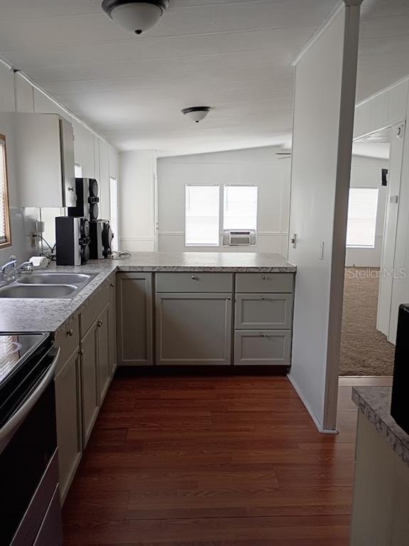 10411 Ratell Avenue Gibsonton, FL 33534 - Photo 9 of 15 a kitchen with wooden floors appliances and sink