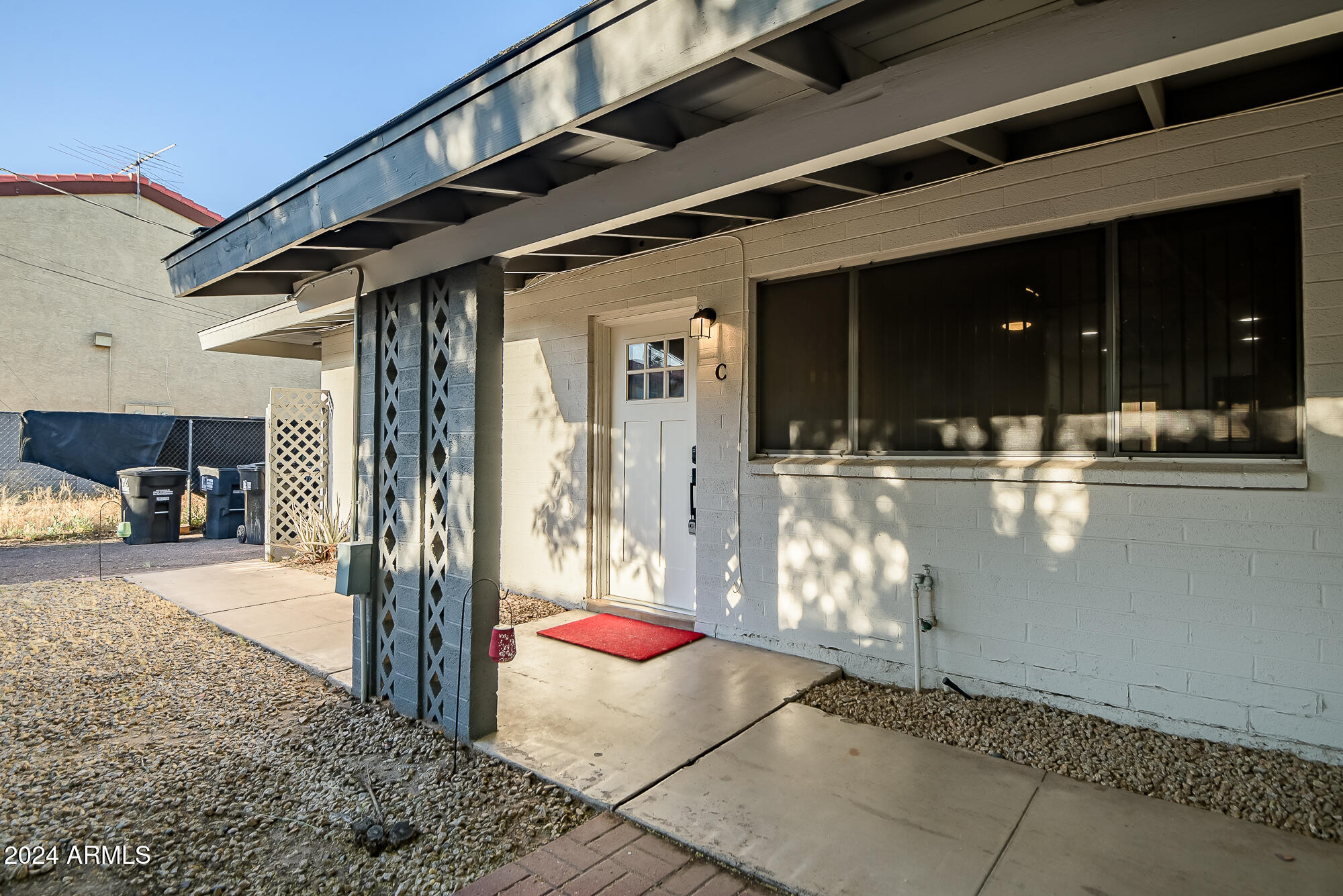 7832 East Heatherbrae Avenue, Unit C Scottsdale, AZ 85251 - Photo 14 of 48 a view of a porch with dining table and chairs