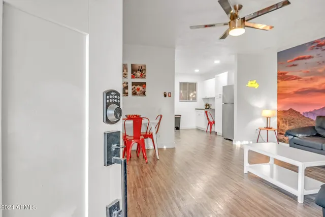 a view of a dining room with furniture and a chandelier fan