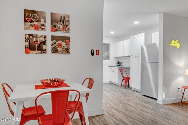 a view of a dining room with furniture and a kitchen view