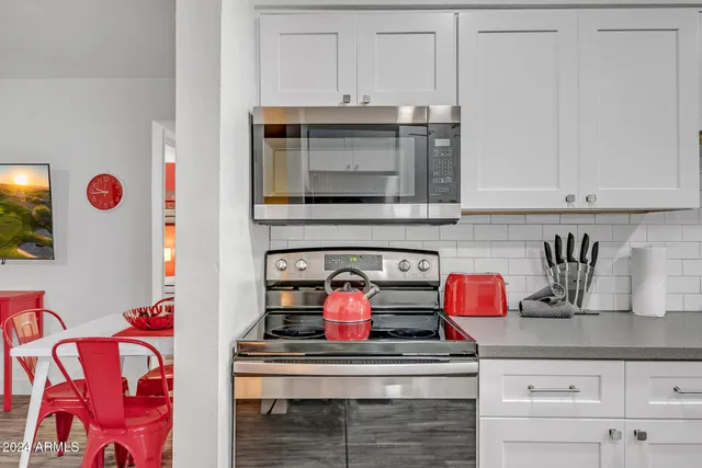 a stove top oven sitting inside of a kitchen