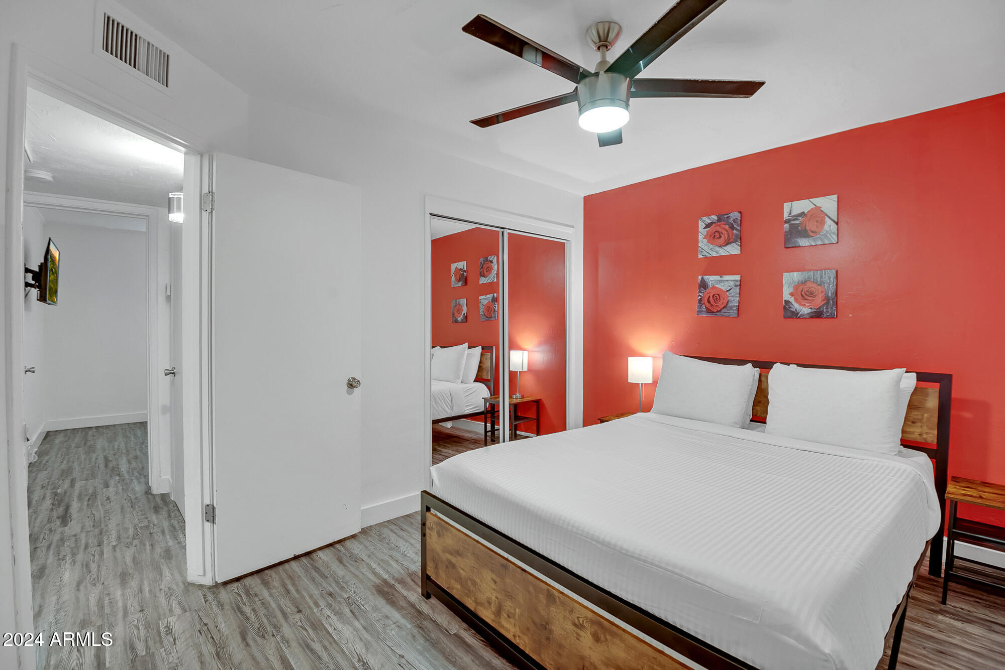 7832 East Heatherbrae Avenue, Unit C Scottsdale, AZ 85251 - Photo 27 of 48 a bedroom with a large bed and a chandelier