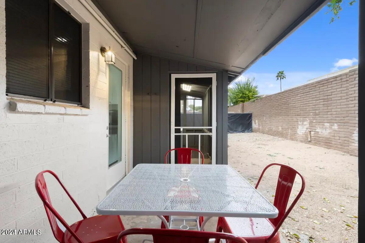 7832 East Heatherbrae Avenue, Unit C Scottsdale, AZ 85251 - Photo 29 of 48 a view of a dining room with furniture and wooden floor