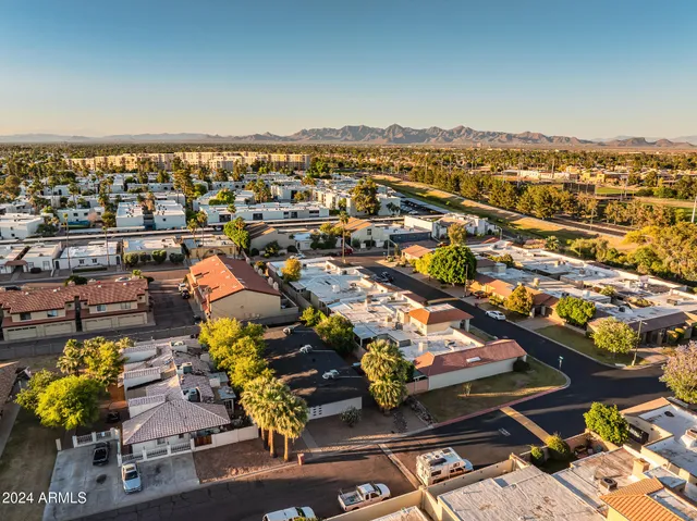an aerial view of a residential houses with outdoor space