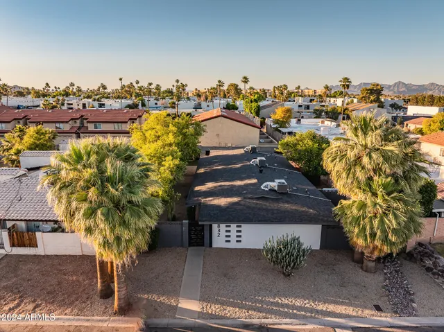 an aerial view of residential houses with outdoor space